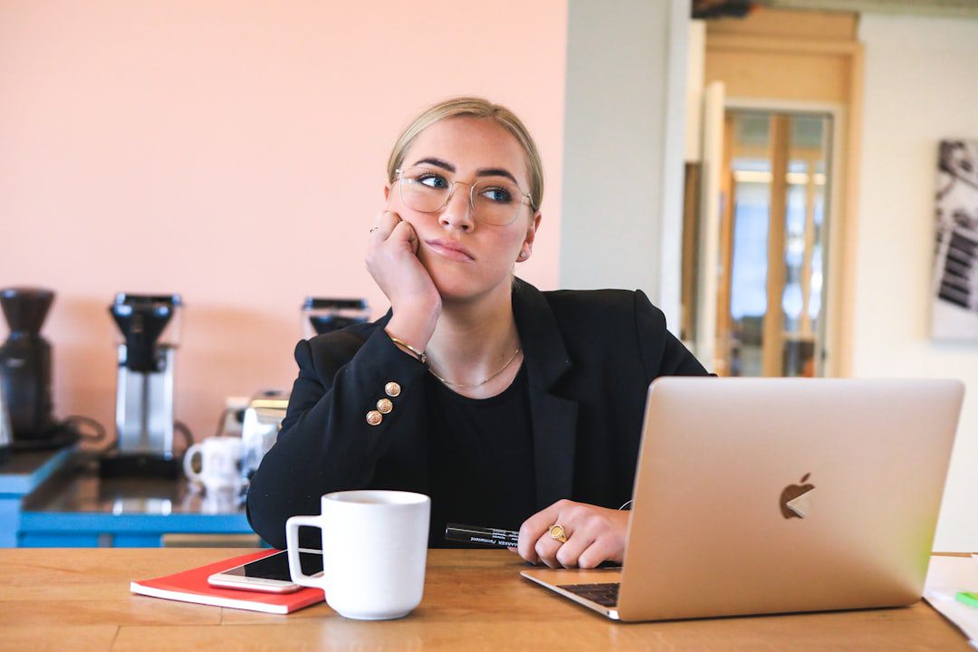 Photo by Magnet.me woman in black long sleeve shirt using macbook
